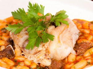 Slow roasted herb chicken on a bed of Turkish flagelot bean stew with traditional Cypriot salami sausage