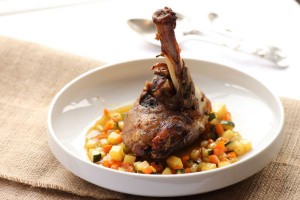 Slow roasted lamb shank with brunoise vegetables in a carrot jus